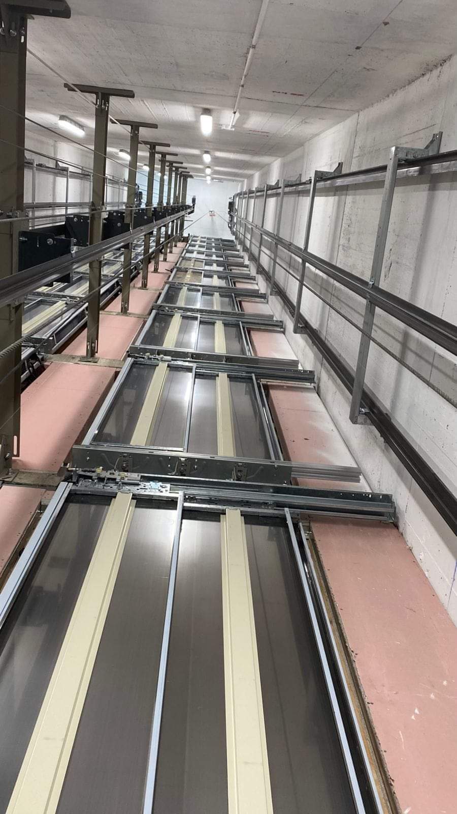 Elevator shaft with guide rails and landing doors during installation