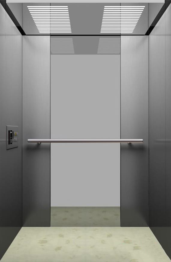 Elevator cabin with brushed steel walls and handrail