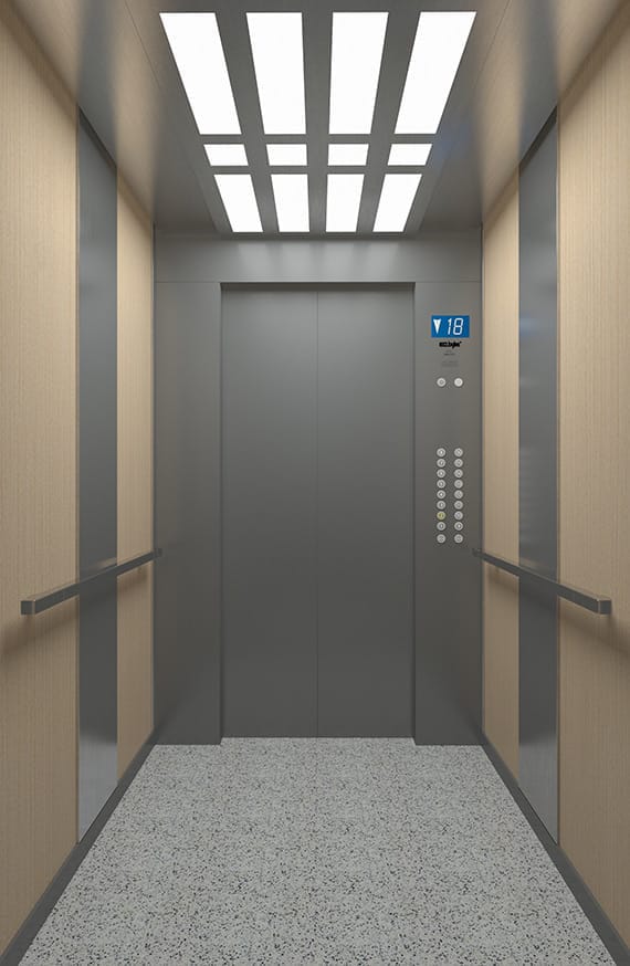 Commercial elevator cabin with wood finish walls and handrails
